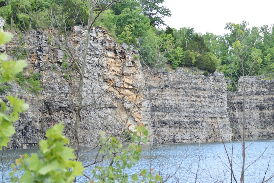 Old quarry wall with crystal blue water